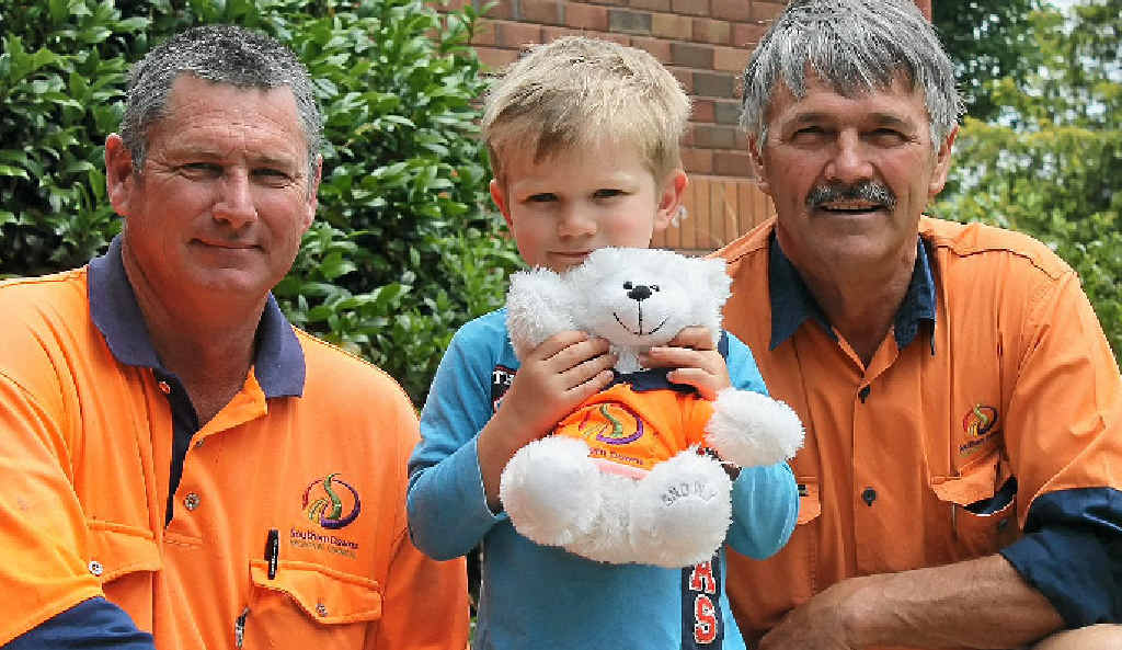 Operation Teddy Rescue crew Chris Witney and Les Palmer present Thomas Telfer, 3, with his new bear, Mr Dig.